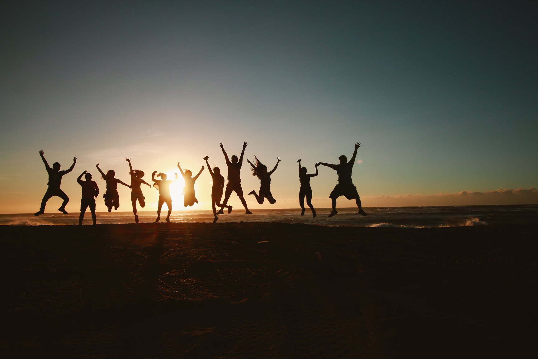 Silhouette Photography of Group of People Jumping during Golden Time